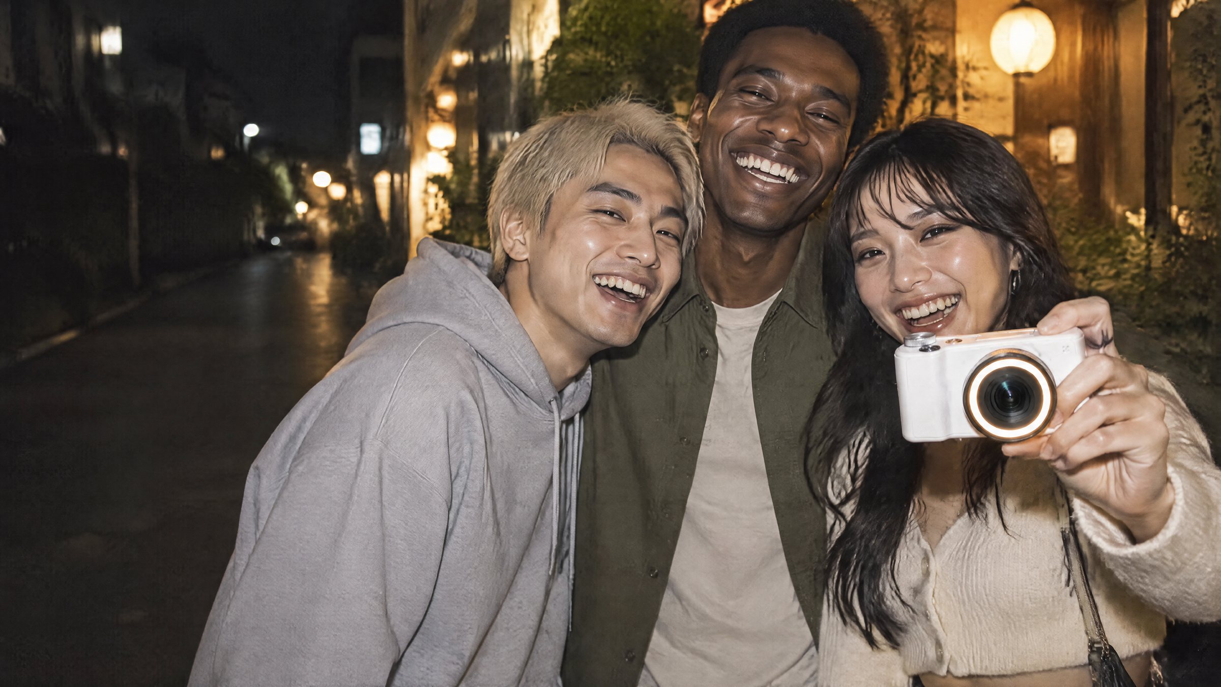 Friends laughing on a city street at night, lit by the ring light of the camera